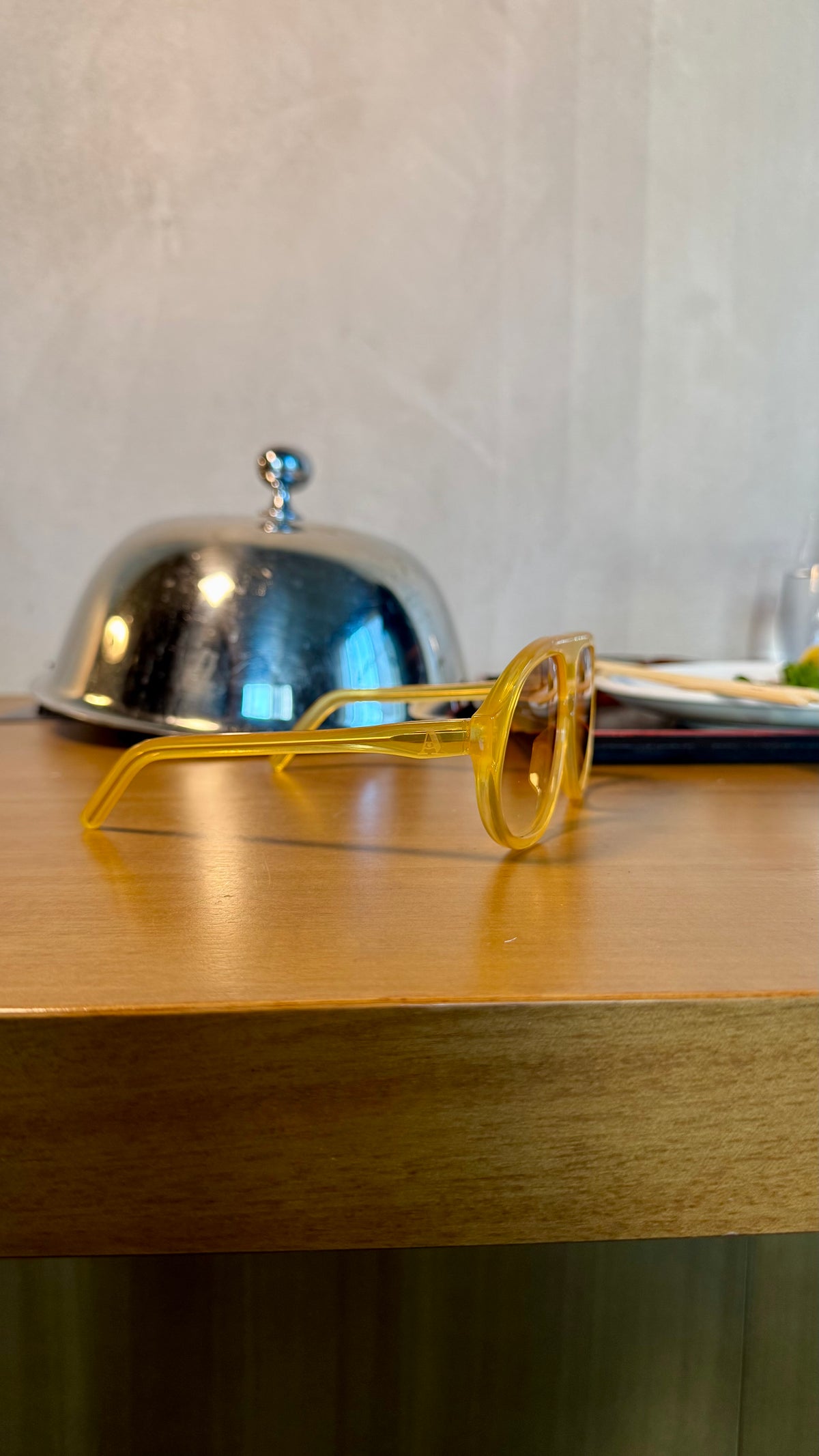 Handcrafted yellow acetate luxury eyewear by ANNTURE with amber tinted lenses, translucent sculptural frame from the “…in the morning” collection