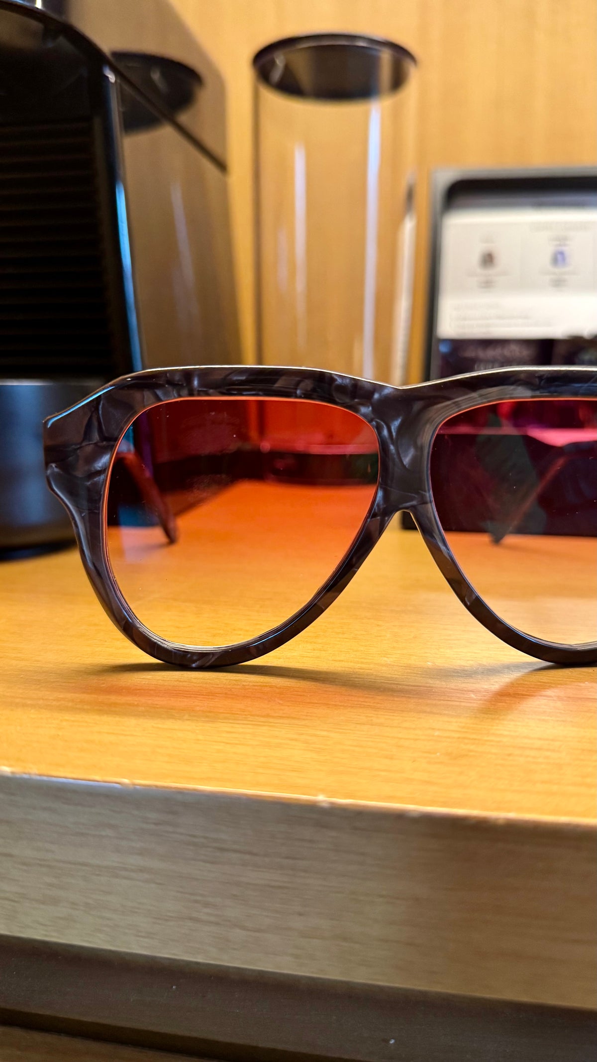 Handcrafted brown marbled acetate luxury eyewear by ANNTURE with red tinted lenses, sculptural frame from the “…in the morning” collection