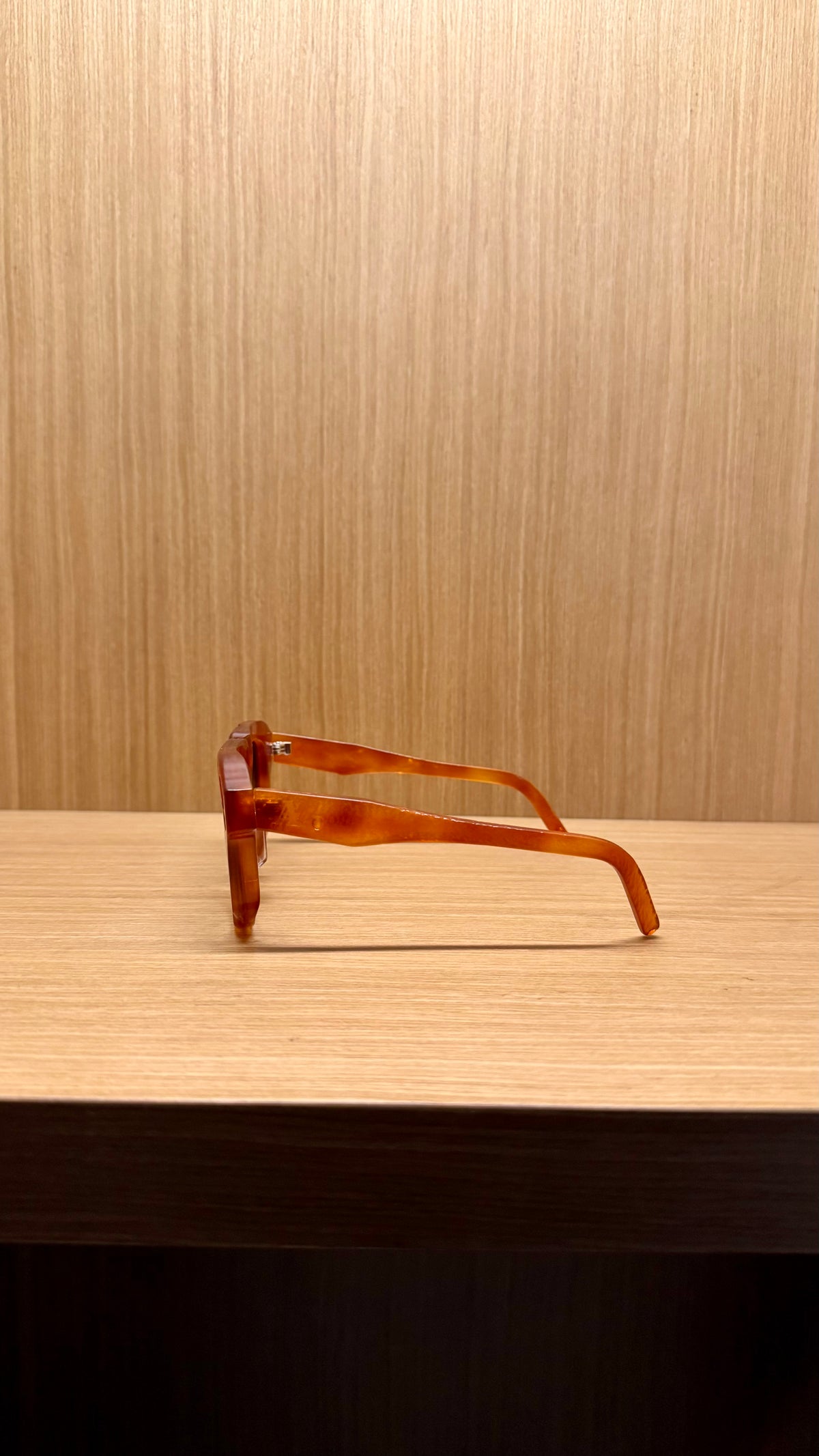 Handcrafted amber acetate luxury eyewear by ANNTURE with soft tinted lenses, warm sculptural frame from the “…in the morning” collection