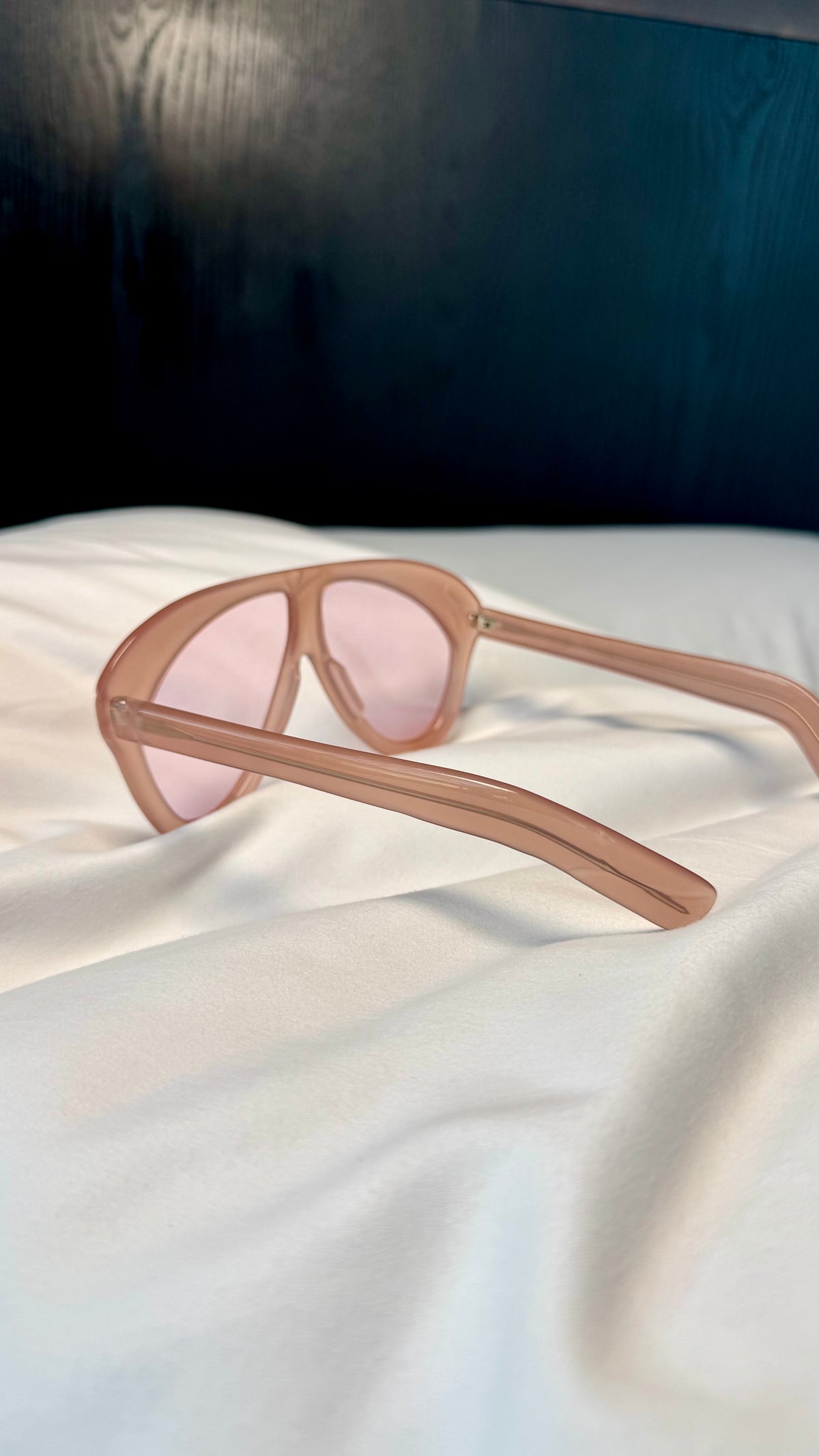 Handcrafted pink acetate luxury eyewear by ANNTURE with rose tinted lenses, oversized sculptural frame from the “…in the morning” collection