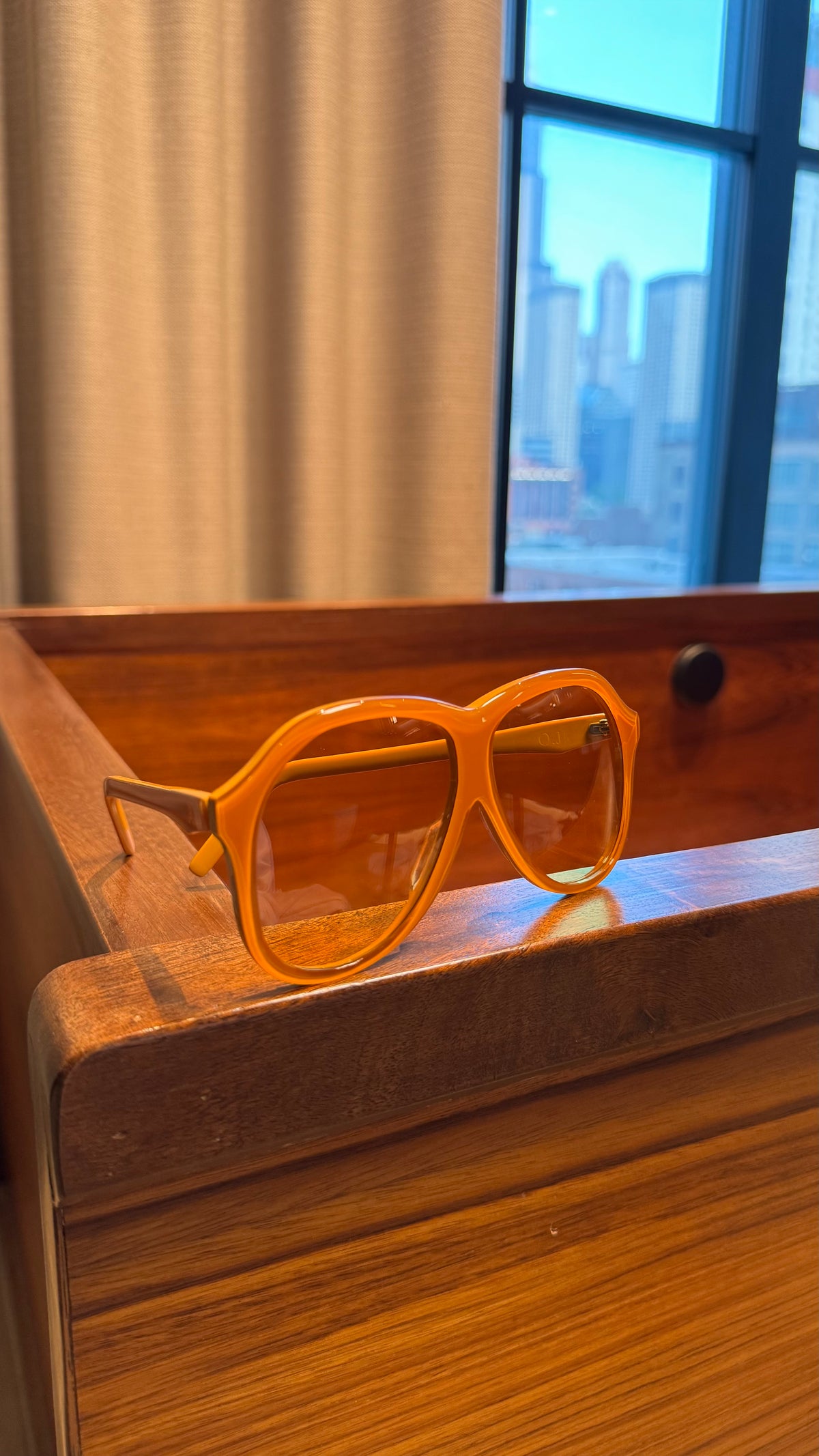 Handcrafted orange acetate luxury eyewear by ANNTURE with tinted lenses, bold sculptural frame from the “…in the morning” collection