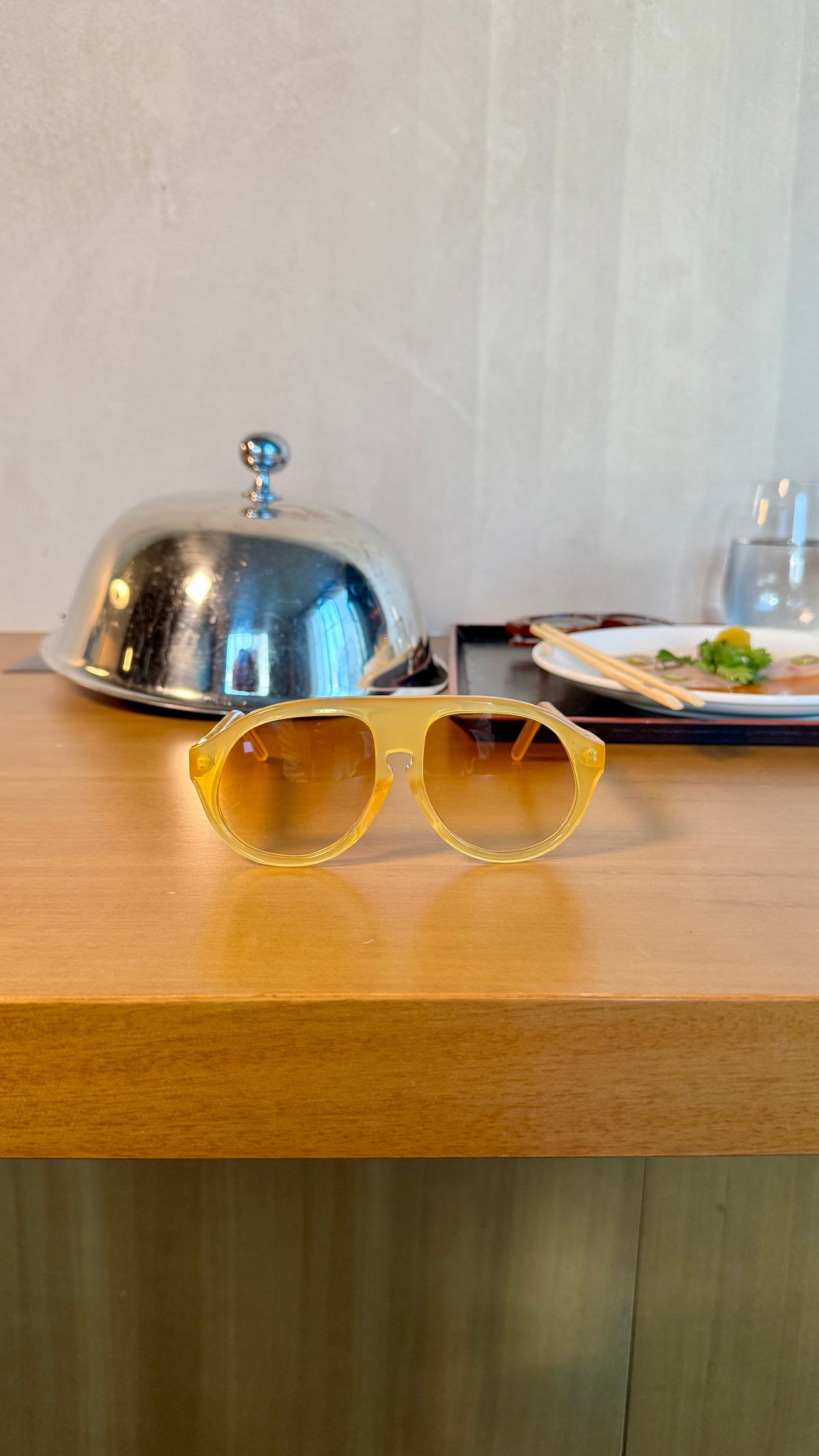 Handcrafted yellow acetate luxury eyewear by ANNTURE with amber tinted lenses, translucent sculptural frame from the “…in the morning” collection