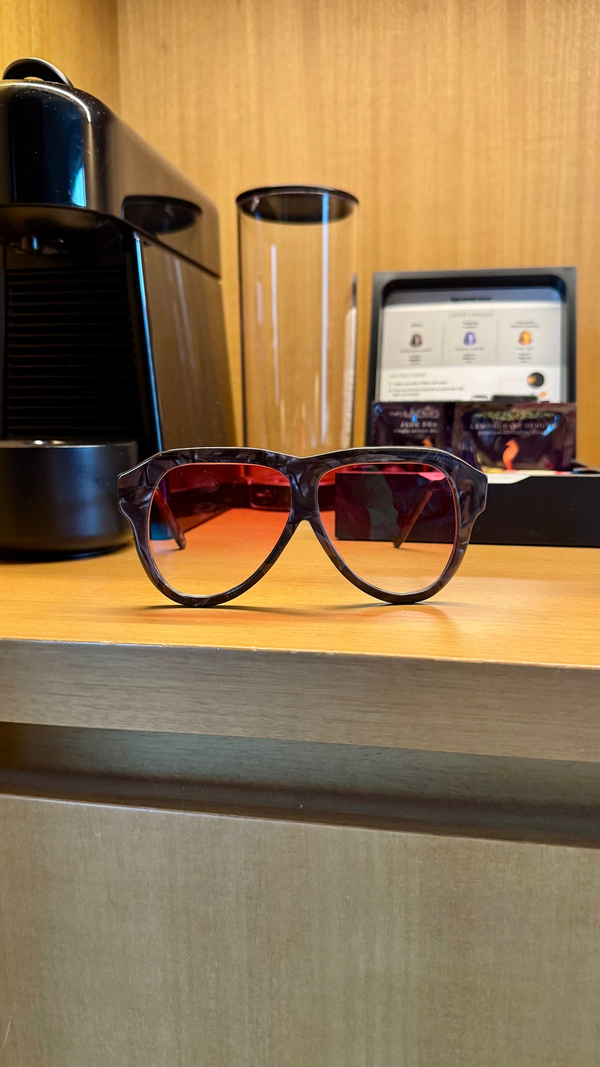Handcrafted brown marbled acetate luxury eyewear by ANNTURE with red tinted lenses, sculptural frame from the “…in the morning” collection