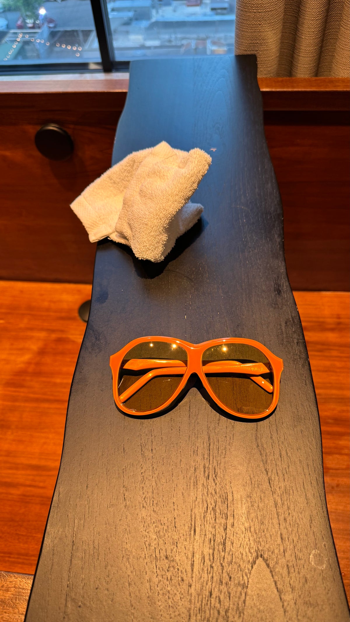 Handcrafted orange acetate luxury eyewear by ANNTURE with tinted lenses, bold sculptural frame from the “…in the morning” collection